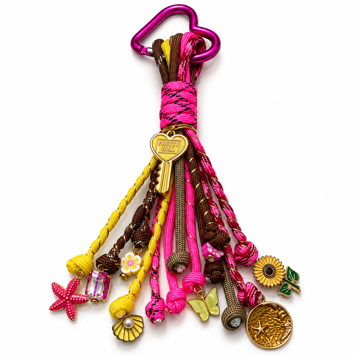 Pink and yellow Pretty Girl paracord bag charm featuring colorful cords, a decorative clip, and assorted dangling charms by D'Mood Kreationz.
